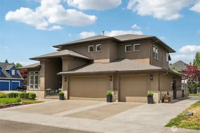 From this angle, the home’s architectural grandeur is on full display—highlighting the expansive footprint, rich stucco finish, and secure gated side access. Designed with luxury, functionality, and curb presence in mind, this residence blends form and function in one of Vancouver’s most coveted neighborhoods