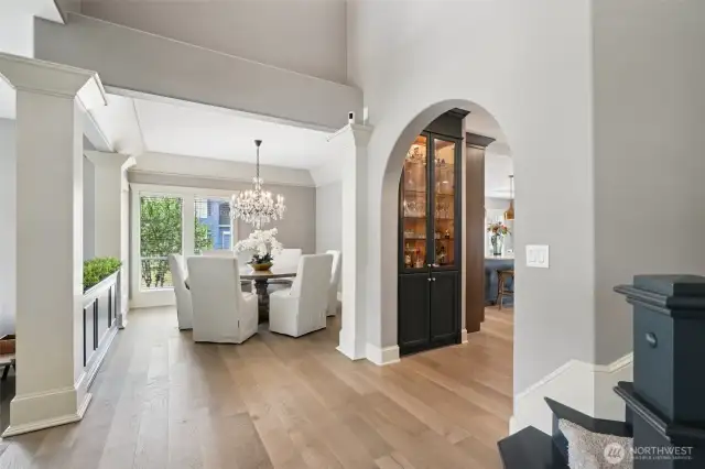 Framed by stately columns and graceful archways, this open dining space flows effortlessly toward the chef’s kitchen. Custom millwork and built-ins offer beauty and functionality, while soaring ceilings and five-piece base molding elevate the experience. The perfect blend of classic charm and modern comfort