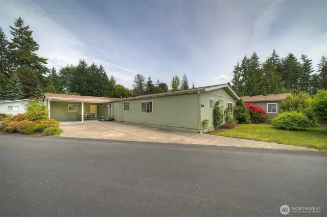You are greeted with a lovely lawn area, gorgeous roses and established landscaping all around. The generous parking area leads to side door with easy one step-up entrance into the home.