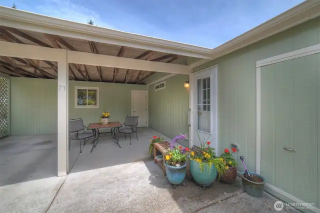 We all love the "family entry". The carport is spacious enough to park a car, but also can double as a covered patio . The back wall with window and door fronts a handy workshop/storage space. Plenty of room to store your Christmas decorations, lawn mower, and special projects.