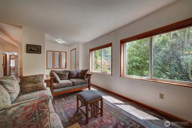 Generous windows provide an amazing amount of natural light throughout this home while the established surrounding landscaping enhances the views and provides privacy.
