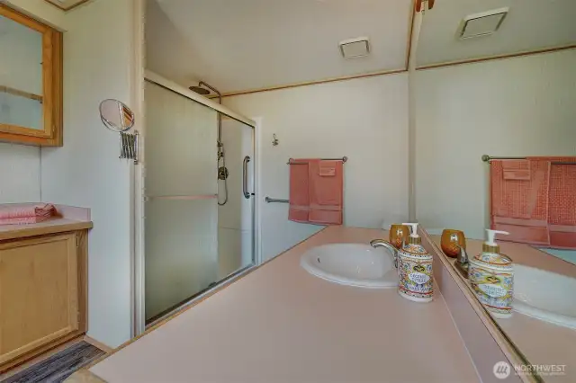 The new walk-in shower boasts an overhead rain style shower head with adjustable hand spray and the convenience of a removable bench seat.