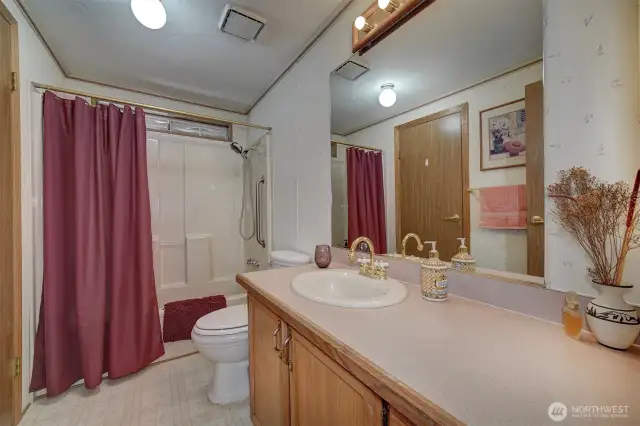 The guest bathroom has full tub and shower.