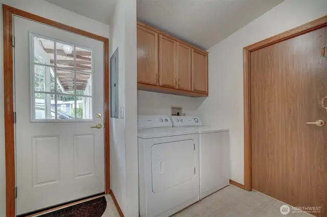Back around again to the family entrance. Easily bring your groceries and packages through this spacious laundry room and into the kitchen and family room.