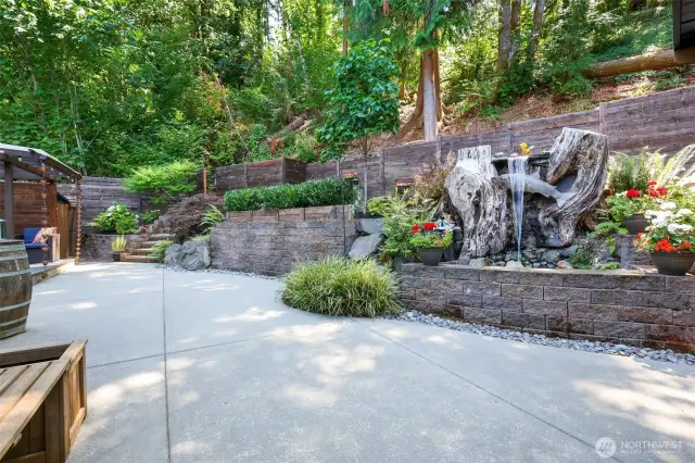 Backyard is thoughtfully designed with landscape lighting and terraces.  At night, it looks like a dreamy oasis from your primary bedroom.