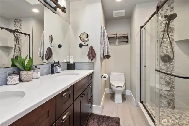 Primary bathroom is gorgeous, with heated floors, large shower, and dual vanity sink.