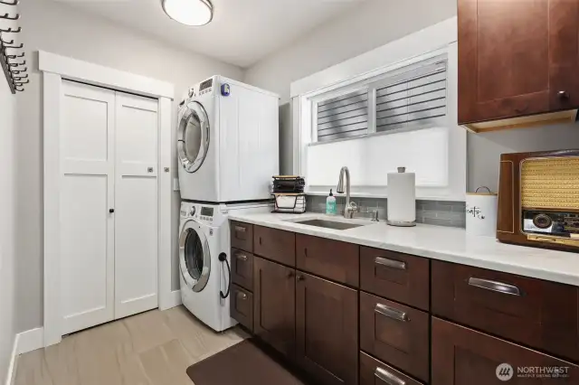 Utility room provides indoor storage and plenty of space for laundry & folding clothes.