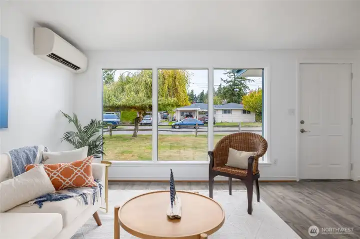 The living room with a cozy mini split to keep things warm and the large windows to overlook the lovely neighborhood.