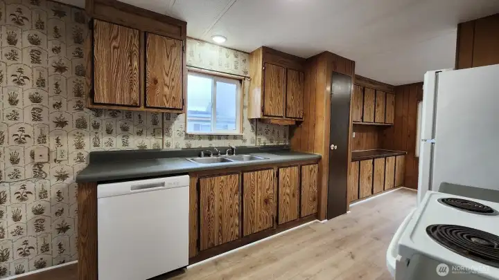 Large open kitchen with lots of cupboards.