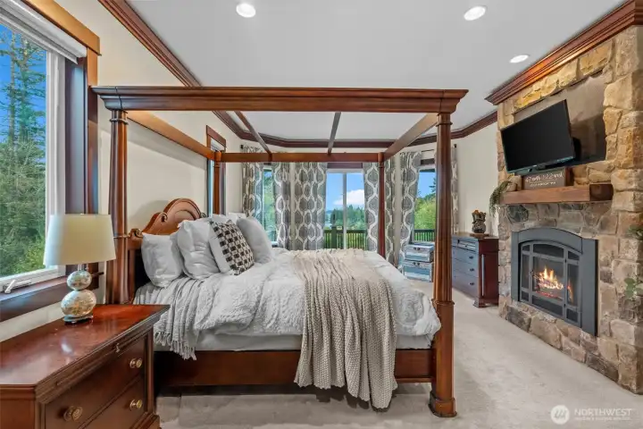 Primary bedroom with deck access and fireplace
