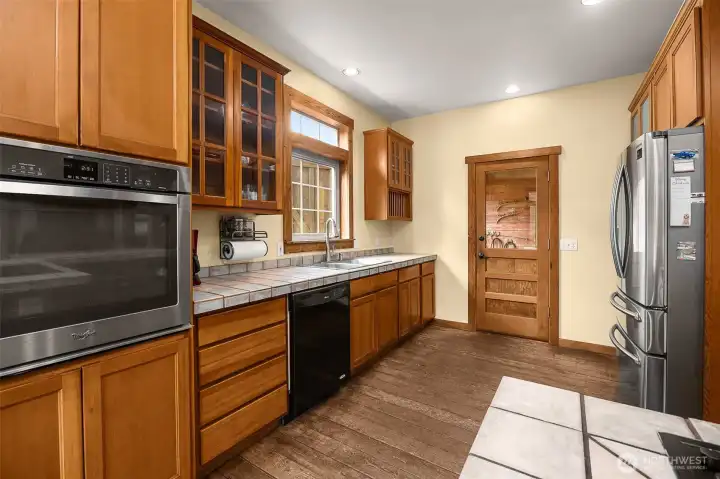 Kitchen with door looking out into the stall and breezeway area.