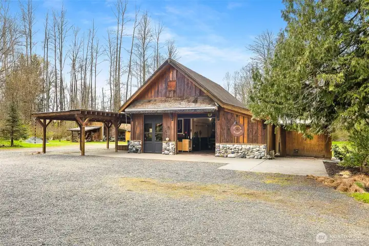 Shop with 4-bay carport and large retractable awning.