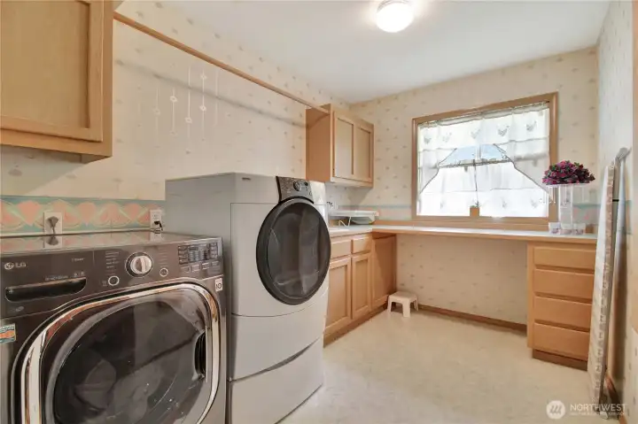 Main floor laundry room with built in ironing board