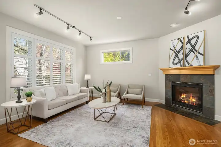 The warm and inviting family room centers around a beautiful brick fireplace, creating a cozy focal point perfectly complemented by rich hardwood floors, fresh neutral paint, and large windows that fill the space with natural light. With surround sound hook-up and a comfortable, open layout, this relaxed gathering space is ideal for both quiet evenings at home and lively entertaining.
