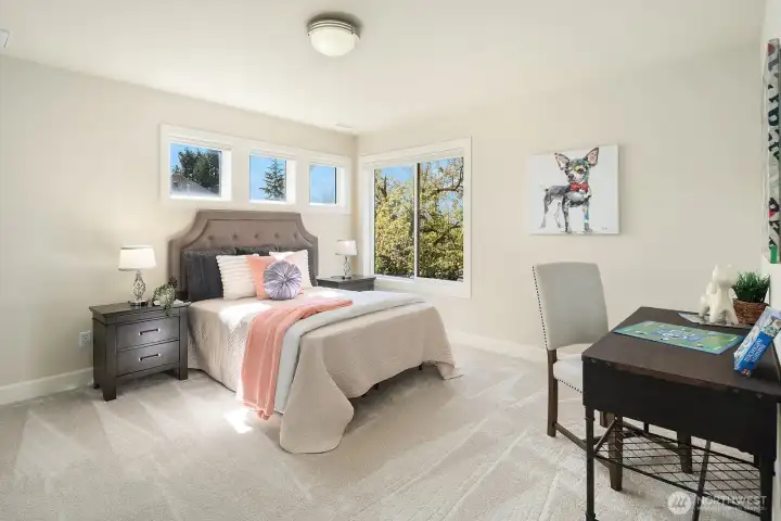 This bright and inviting upper level bedroom offers a comfortable and versatile space, featuring plush carpet, fresh neutral paint, and large windows that fill the room with warm natural light and lovely treetop views. Generously sized and thoughtfully finished, this well-appointed room is perfectly suited for family members, guests, or a dedicated home office or study.