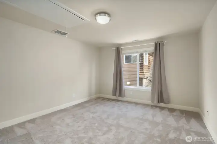 This clean and comfortable upper level bedroom features fresh neutral carpet, crisp paint, and a bright window that brings in natural light to create a welcoming and versatile space. Ready for immediate move-in, this well-sized room offers the flexibility to serve as a guest room, children's bedroom, or quiet home office with ease.