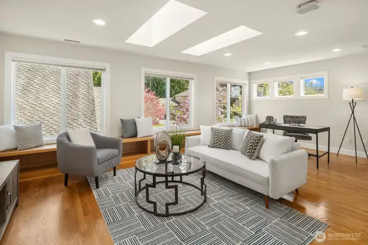 This spectacular upper level bonus room is flooded with natural light from a dramatic wall of windows and skylights, creating a bright and versatile space perfect for a media room, playroom, home office, or additional living area. The rich hardwood floors, fresh neutral finishes, and generous proportions make this exceptional flex space one of the home's most impressive and sought-after features.