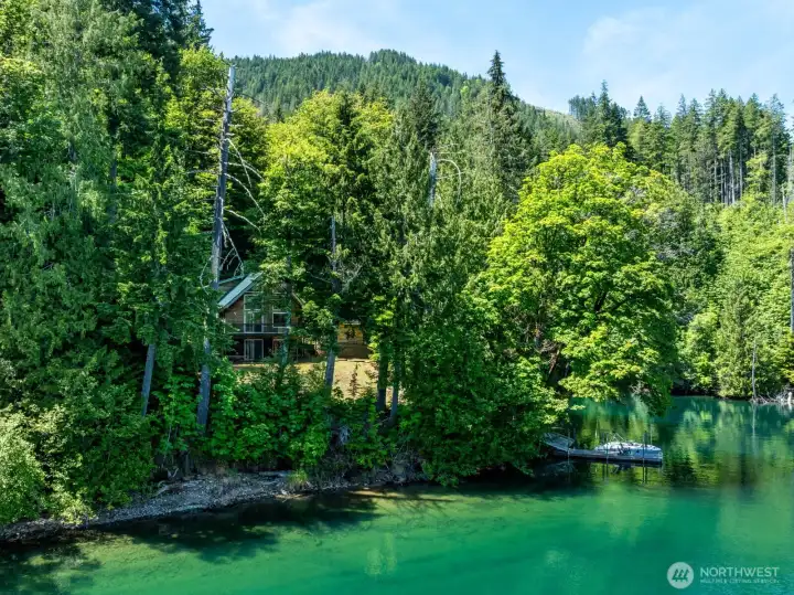 Imagine waking up to a wall of windows to see forrested lakeview and mountains, and then walking down to your privated floating dock to fish.