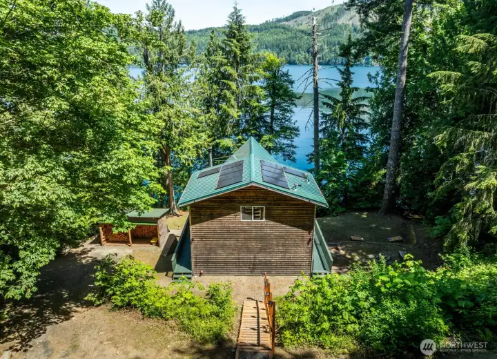 Low Maintenance metal roof has solar panels for off-grid living.