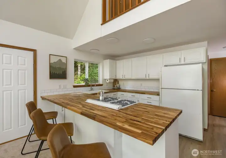 The gas range has a downdraft that receeds into the countertop with the push of a button.