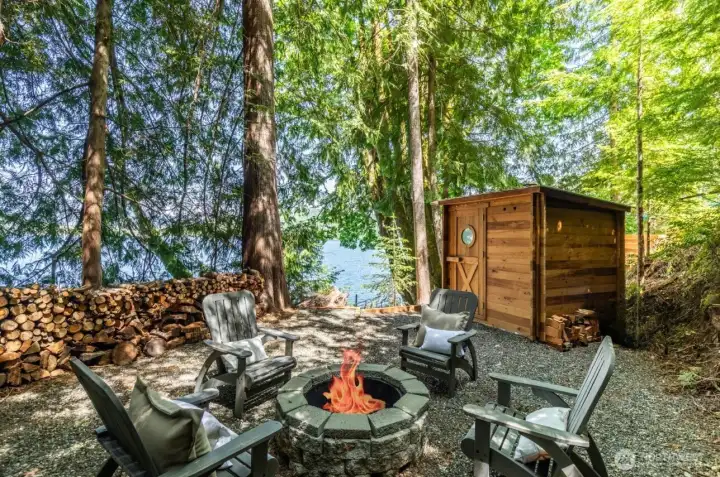 Half way between your house and your private dock, is the 2nd Fire pit located next to redwood sauna.  Turn key living is ready for you as the Redwood sauna, adirondack chairs, firewood, and hammock all convey to new owners with the sale of the house.