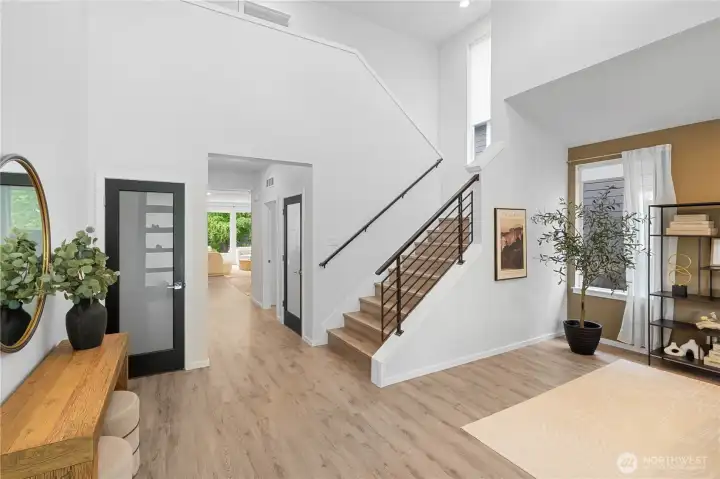 Two story foyer with, grand stair case to your right. Hallway to main living area.