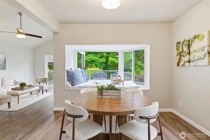 Spacious dining area with bay window that brings in the outdoors.