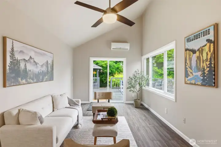 Bright living room with ceiling fan, AC and ample amount of naturual light.