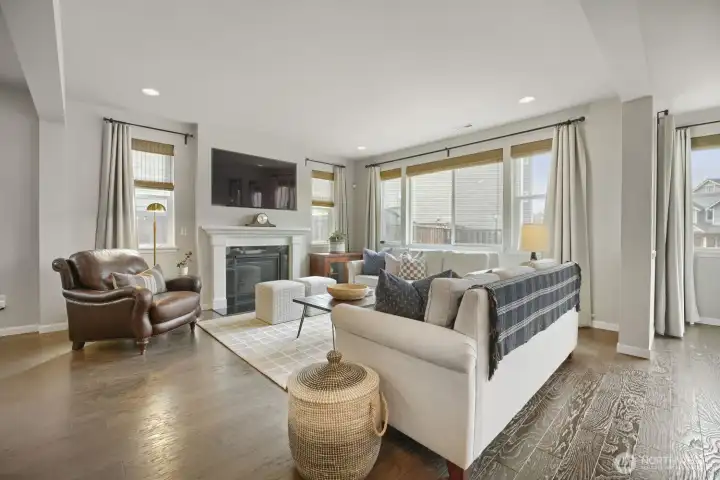 Cozy fireplace anchors this inviting space.