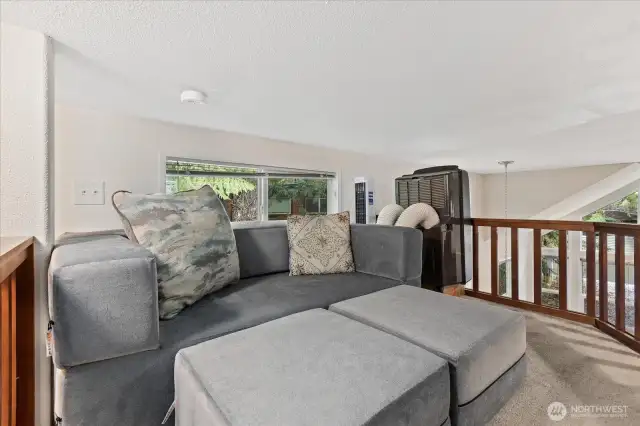 Loft with couch and three beds.