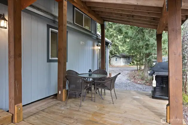 Covered deck with plenty of outdoor seating and a BBQ all included!