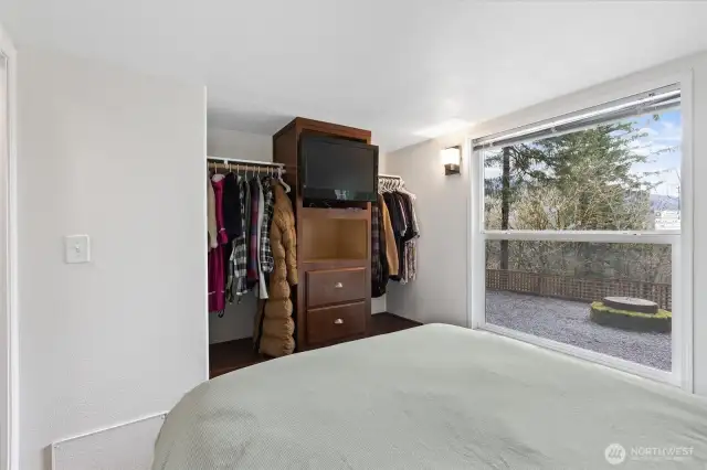 Main bedroom has a view of the ravine and back yard firepit.