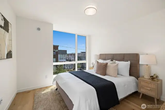Primary suite on the third floor with hardwood floors, walk-in closet and sleek en-suite bathroom.
