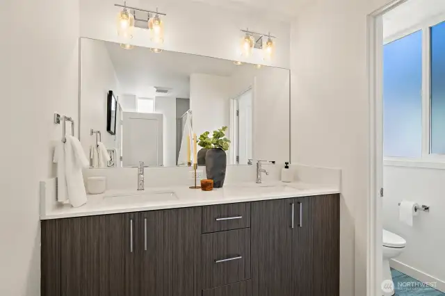 Primary bathroom dual vanity with private water closet.
