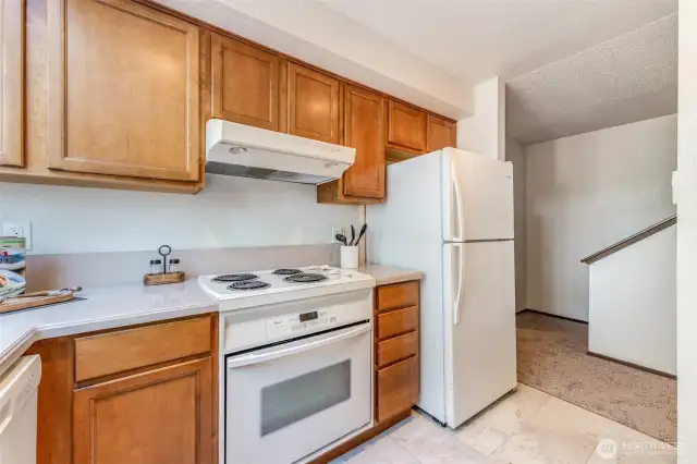 Kitchen has lots of cabinets and counter space.