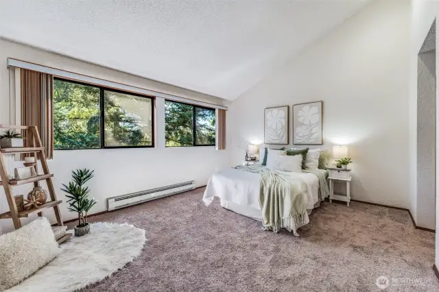 Head upstairs to this large, vaulted, primary bedroom with lots of windows.