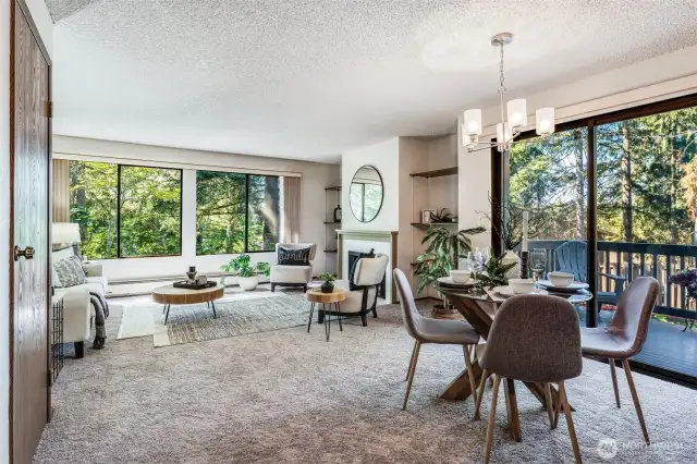 The open kitchen and dining nook are surrounded by huge windows and a large sliding door to the deck.