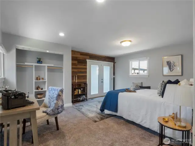 Step into the second bedroom with a wood panel accent wall. This oversized room has a spot for a home office or sitting area. The beautiful French doors lead out to your private wood deck in the back yard.