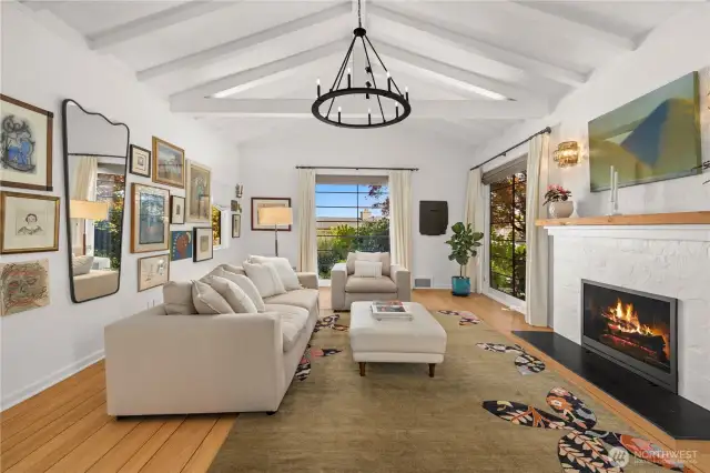 Vaulted beamed ceilings in the living room welcome you home.