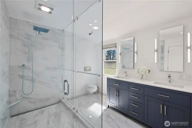 Primary bathroom features an extra large shower and heated floors throughout, even in the shower!