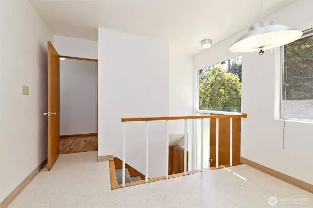 The back set of stairs to the lower level. This is in the extra eating space off of the kitchen. There's a back door here leading to the fully-fenced back yard.