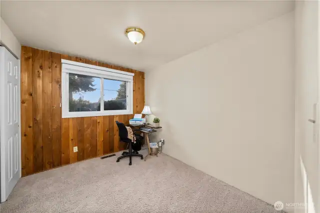 Third bedroom w/ large closet and wood panel accent wall.