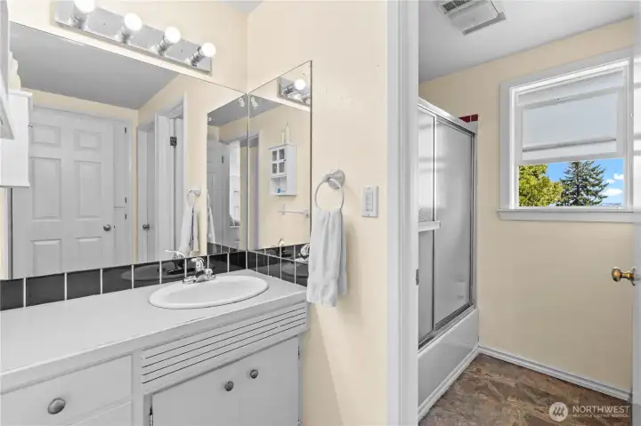 Main bathroom with separate doors to shower and toilet