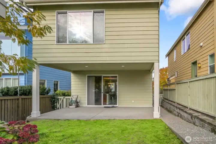 Covered backyard patio and garden space, fenced.
