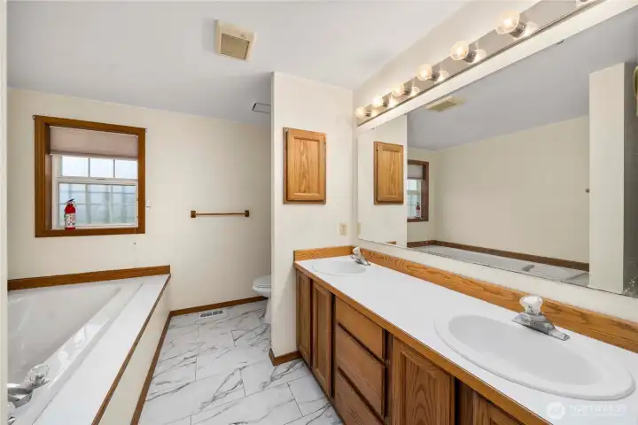 Primary bath has a soaking tub and a separate shower