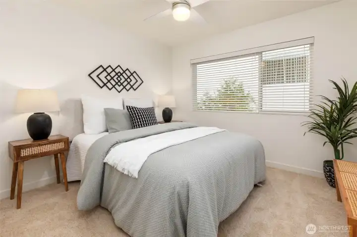 Just down the hall, you'll find this second bedroom with yet another added ceiling fan.