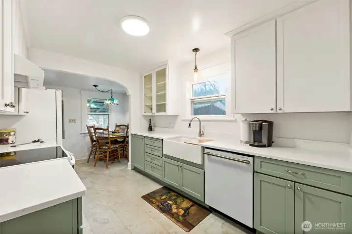 Stunning remodeled kitchen featuring custom wood cabinetry with pull-out storage, a farmhouse sink, and top-of-the-line appliances