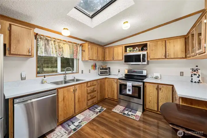 Well-designed kitchen offers ample counter space, storage, and natural light for comfortable, efficient cooking.