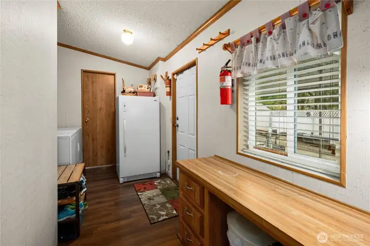 Laundry and utility area offers added counter space and storage, making daily tasks easy and efficient.