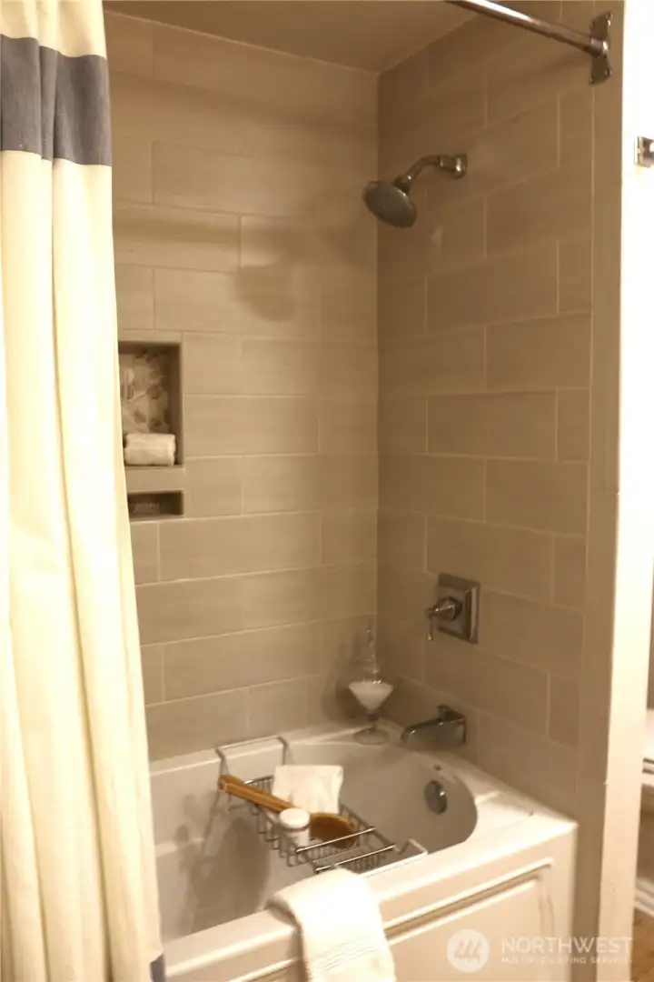 Lower bath, soaking tub with custom tile surround